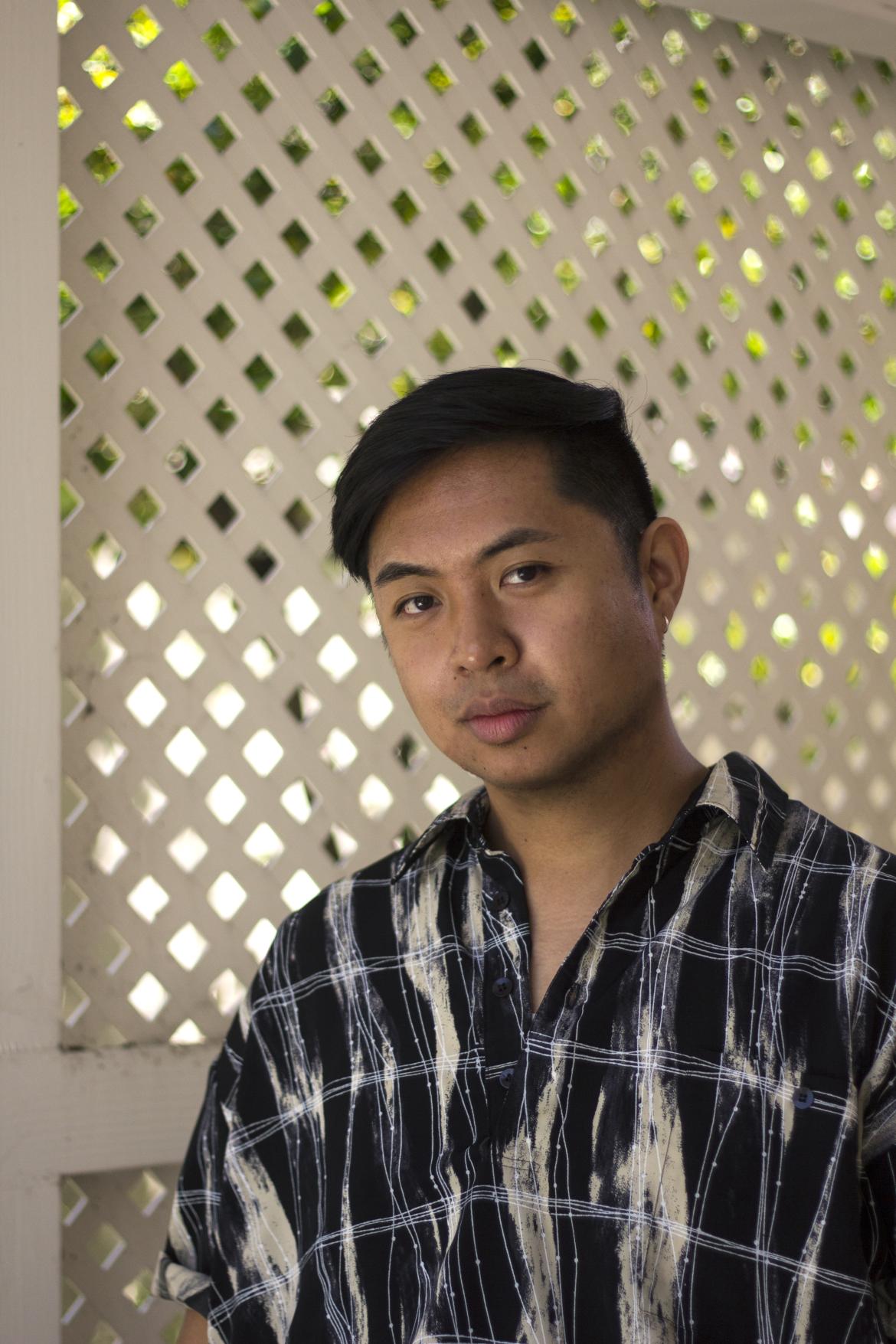 Headshot of Jaime Estepa in front of a white fence