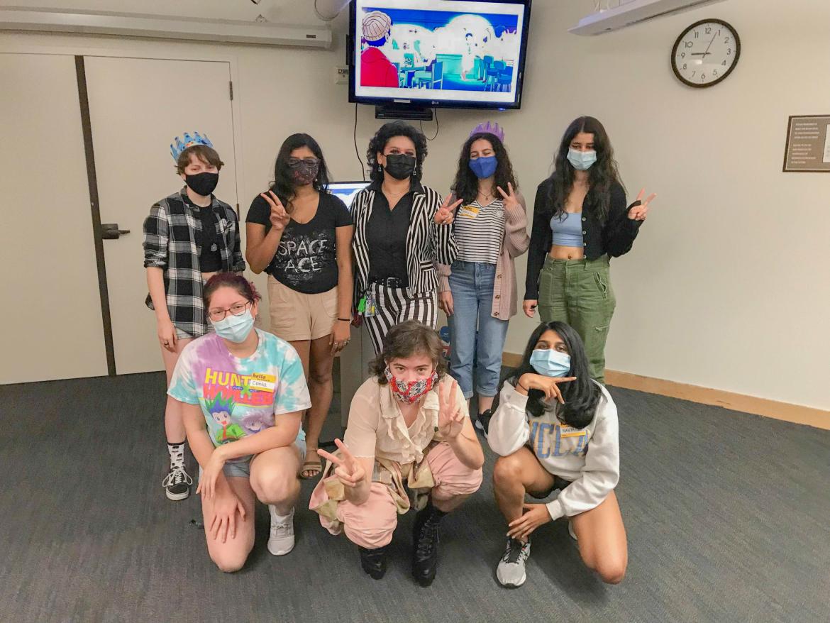 A photo of 8 students from the Ace Awareness social posing with peace signs.