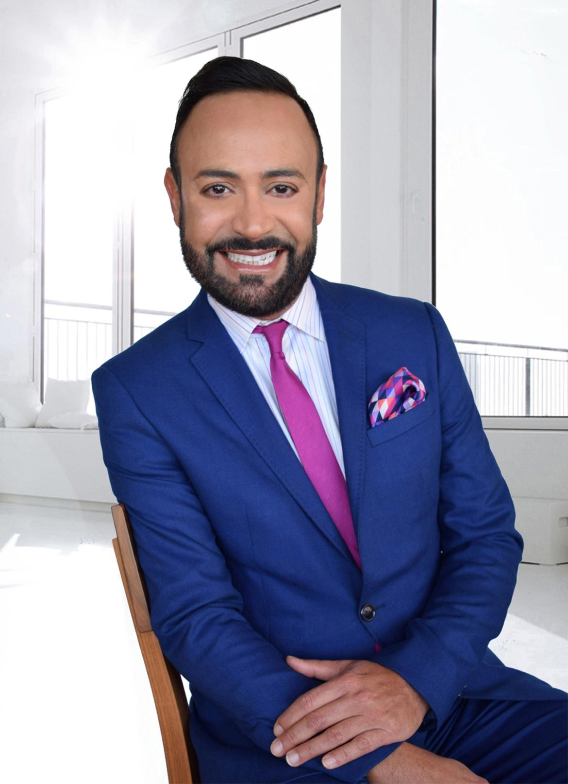 Headhot of Nick Verreos in a blue suit